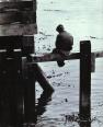Solitary Young man on pilings of pier Monterey California 1970 Copy Righted 1970 © Bruce Perdue, All rights reserved.